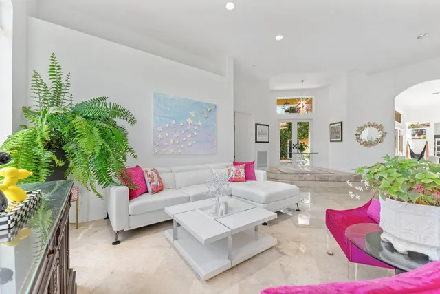 a living room with furniture and a potted plant