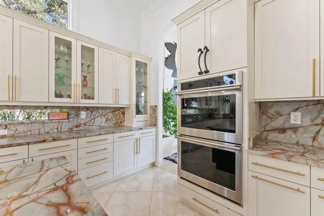 a kitchen with granite countertop white cabinets stainless steel appliances and sink