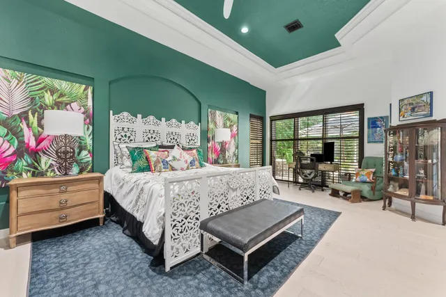 a bedroom with a bed mirror and window