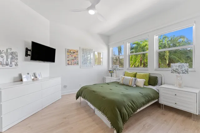 a bedroom with a bed and a flat screen tv