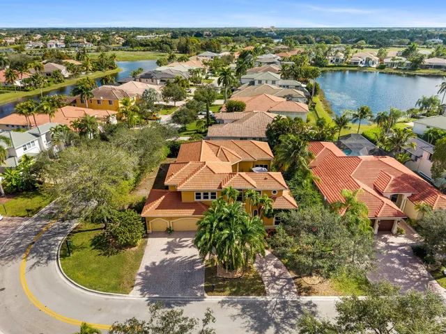 an aerial view of residential houses with outdoor space and river