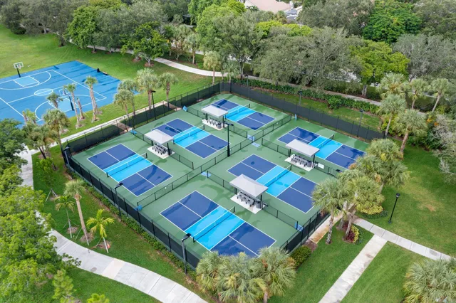 an aerial view of a tennis ground and a yard