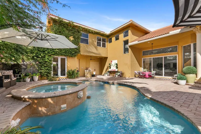 a view of a patio with swimming pool table and chairs