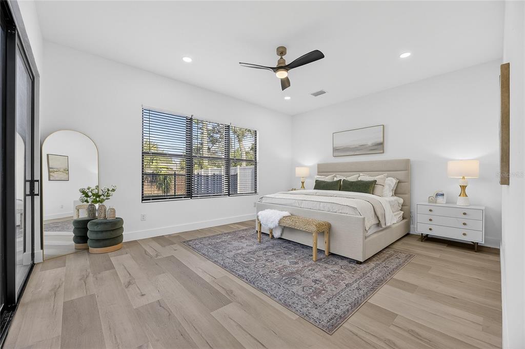 2335 Oak Terrace Sarasota, FL 34231 - Photo 29 of 82 a bedroom with a large bed and a chandelier