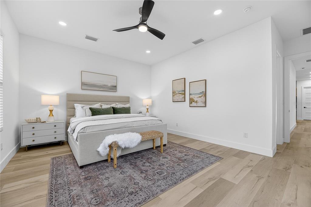 2335 Oak Terrace Sarasota, FL 34231 - Photo 30 of 82 a bedroom with a bed and a chandelier