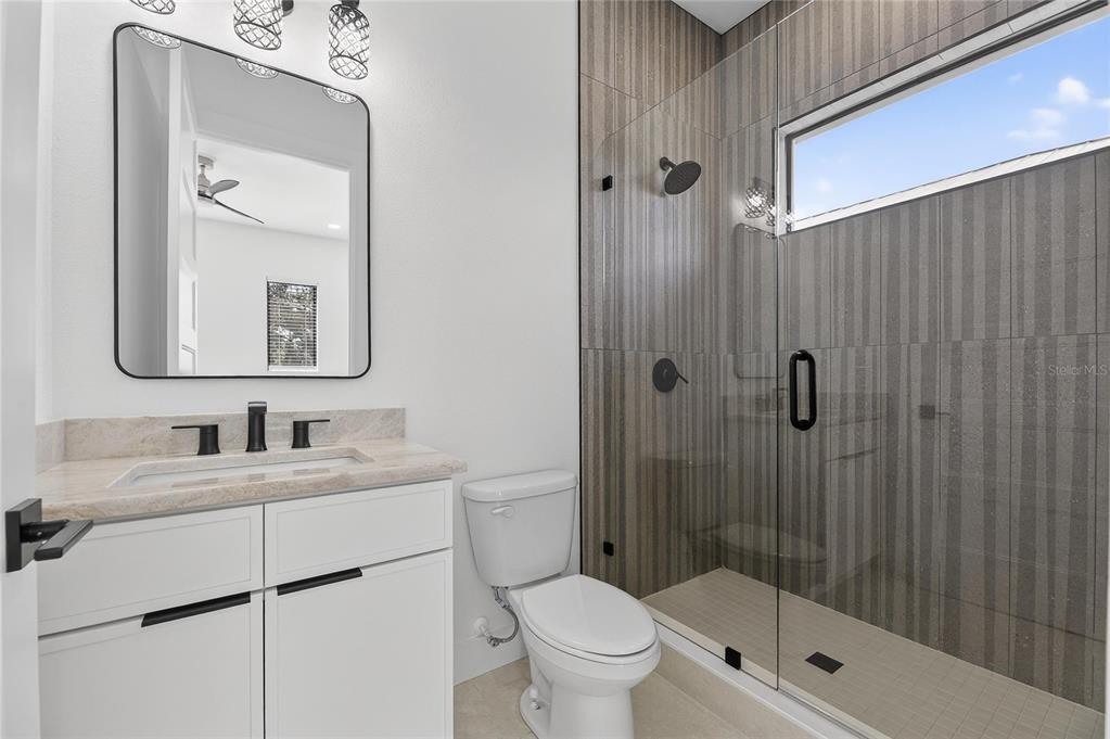 2335 Oak Terrace Sarasota, FL 34231 - Photo 46 of 82 a bathroom with a toilet a sink a mirror and shower