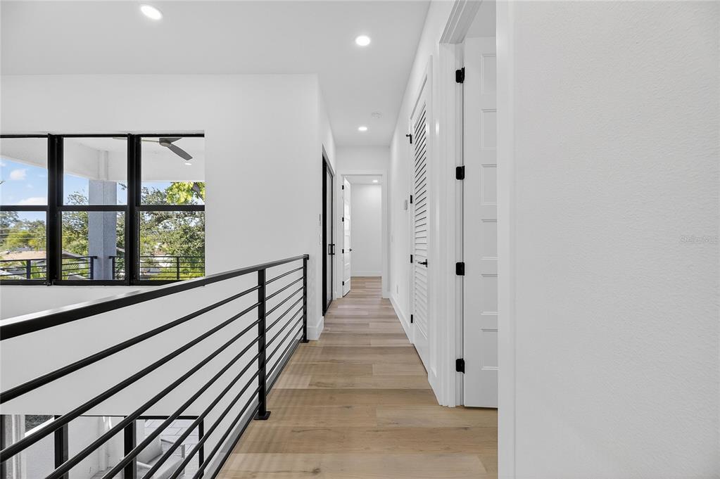 2335 Oak Terrace Sarasota, FL 34231 - Photo 52 of 82 a view of a hallway with wooden floor and windows