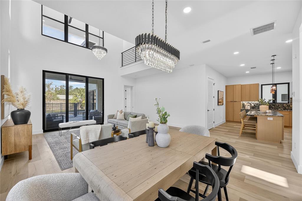 2335 Oak Terrace Sarasota, FL 34231 - Photo 10 of 82 a view of a dining room and livingroom with furniture wooden floor a chandelier