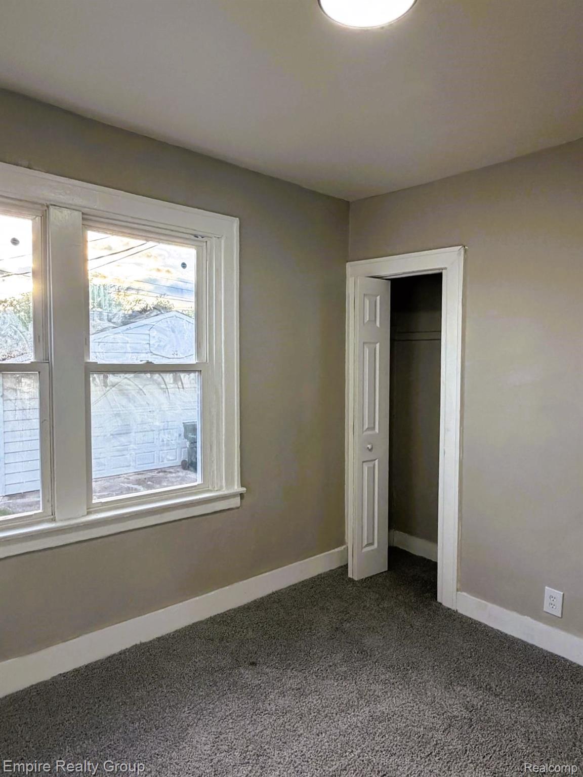 6441 Appoline Street, Unit 1 Dearborn, MI 48126 - Photo 10 of 13 Unfurnished bedroom featuring a closet and dark carpet
