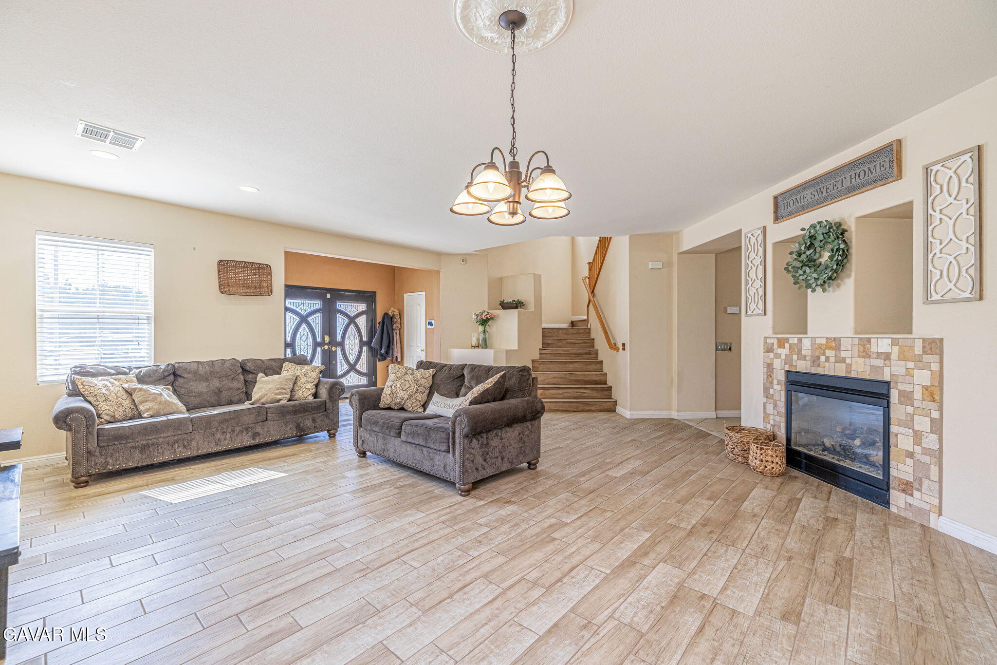 4302 Olivera Place Lancaster, CA 93536 - Photo 12 of 62 a living room with furniture and a fireplace
