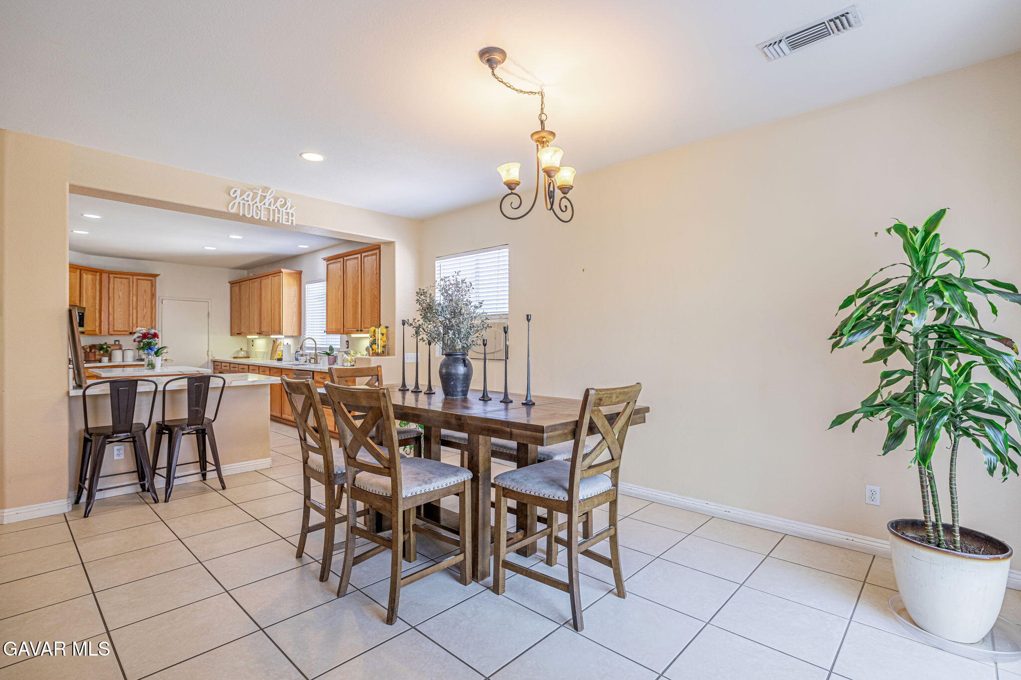 4302 Olivera Place Lancaster, CA 93536 - Photo 19 of 62 a view of a dining room with furniture and a chandelier