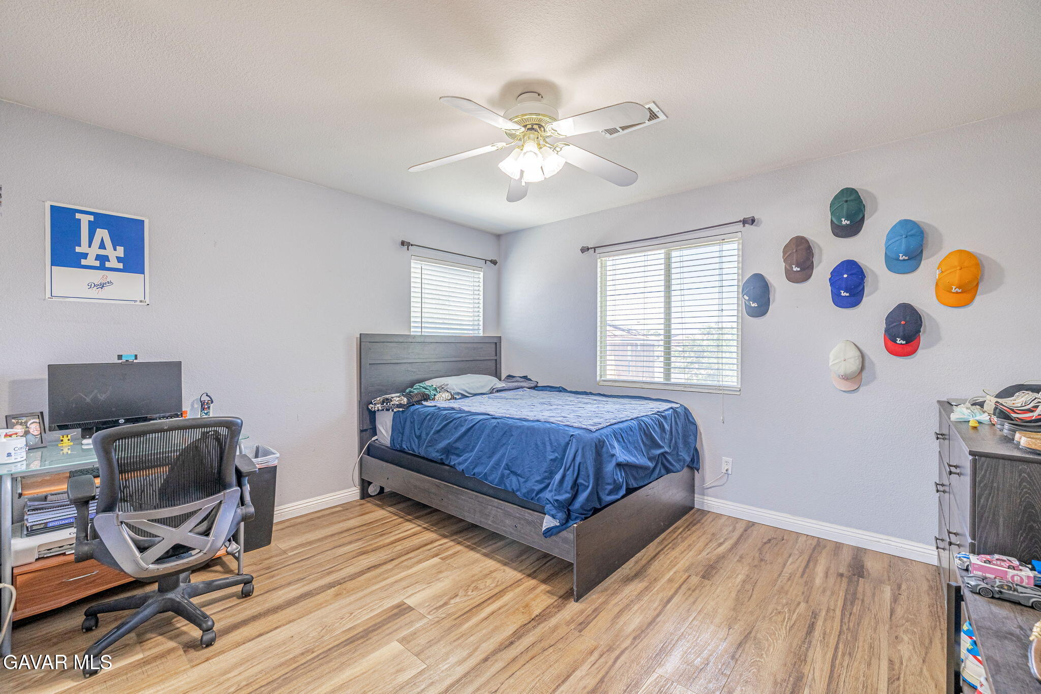 4302 Olivera Place Lancaster, CA 93536 - Photo 37 of 62 a bedroom with a bed and a chandelier