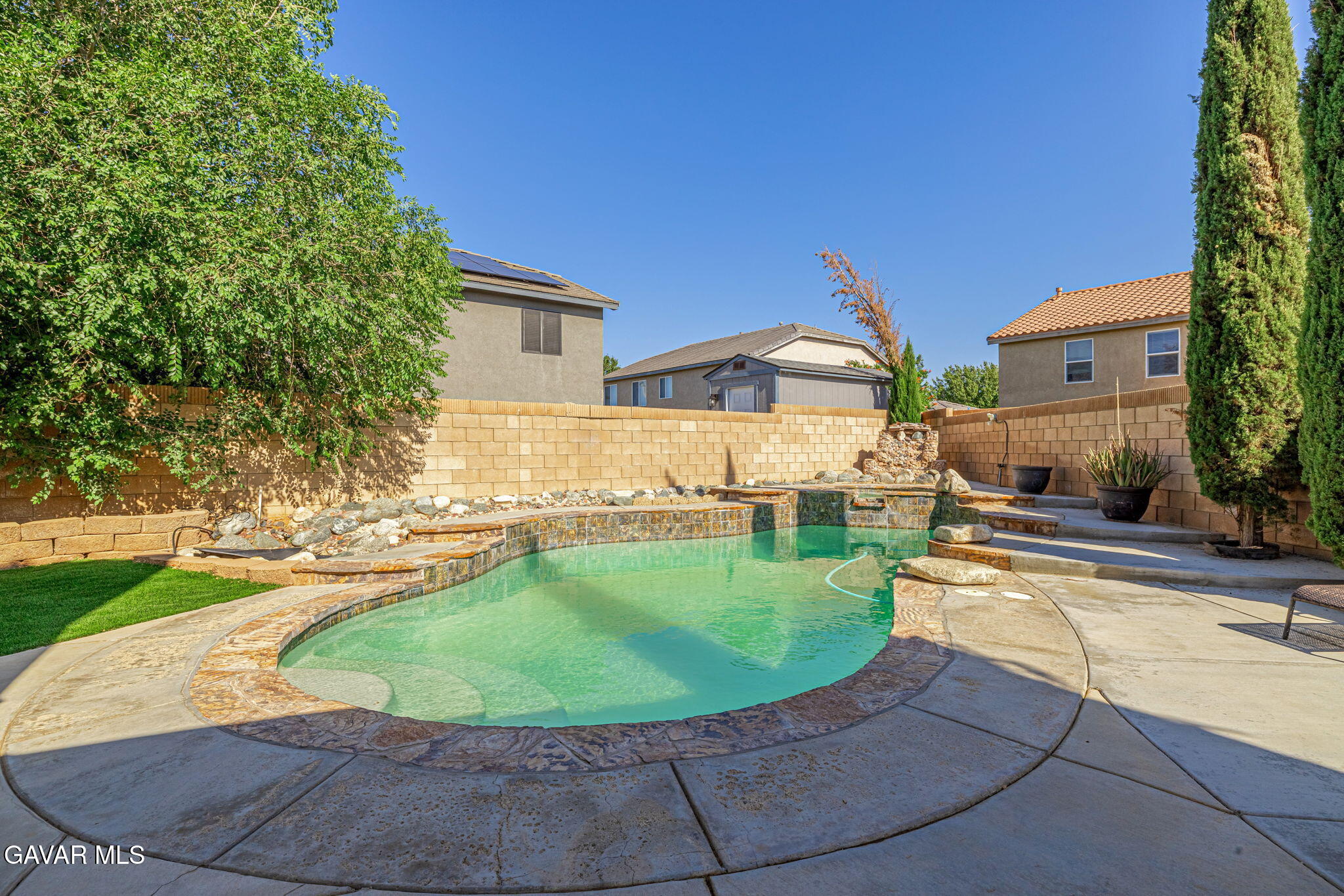 4302 Olivera Place Lancaster, CA 93536 - Photo 44 of 62 a view of a swimming pool with a lounge chairs