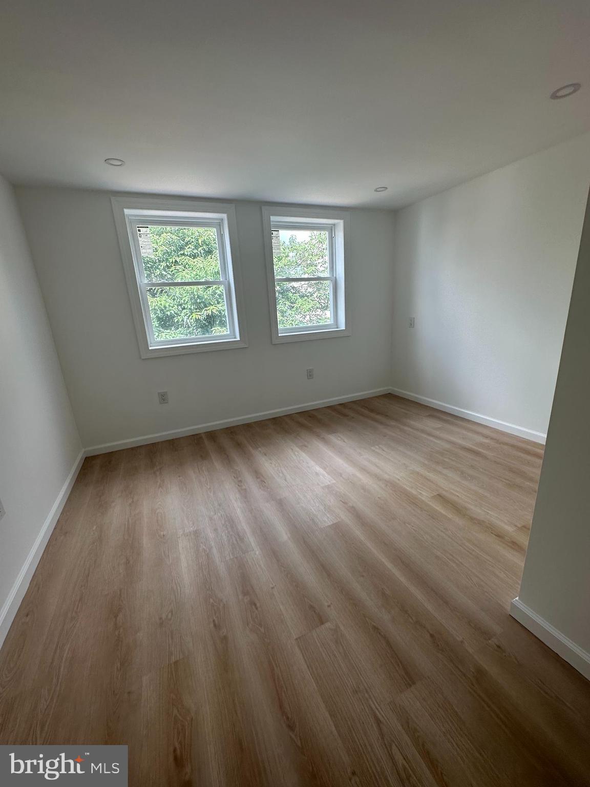 1929 Titan Street Philadelphia, PA 19146 - Photo 10 of 20 an empty room with wooden floor and windows