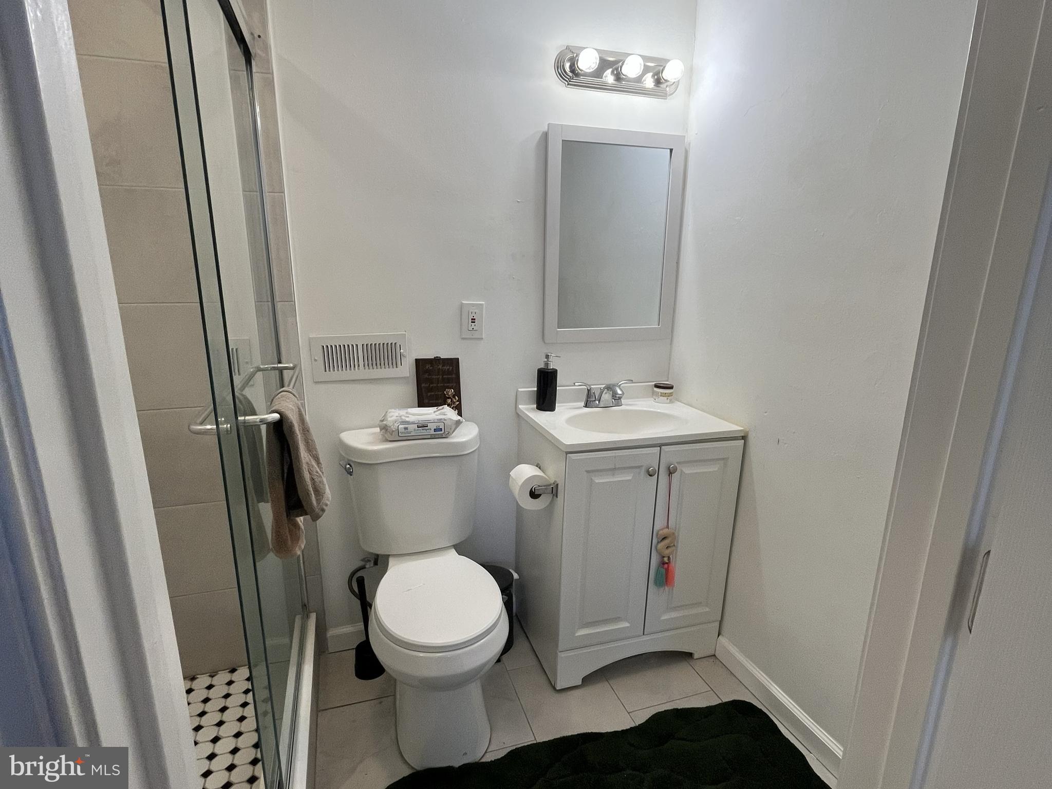 1929 Titan Street Philadelphia, PA 19146 - Photo 4 of 20 a bathroom with a toilet a sink and a mirror
