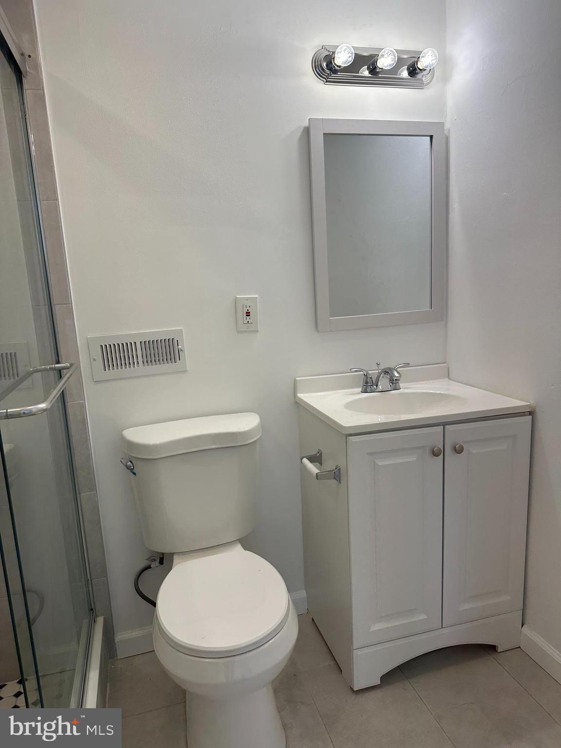 1929 Titan Street Philadelphia, PA 19146 - Photo 9 of 20 a bathroom with a toilet sink and mirror