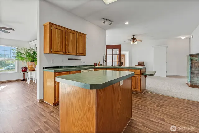 a kitchen that has a sink a table and chairs in it