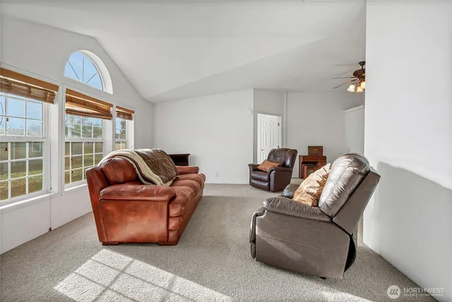 a living room with furniture a window and a chandelier