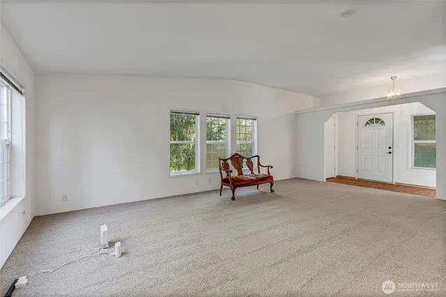 a view of a livingroom with furniture and a window