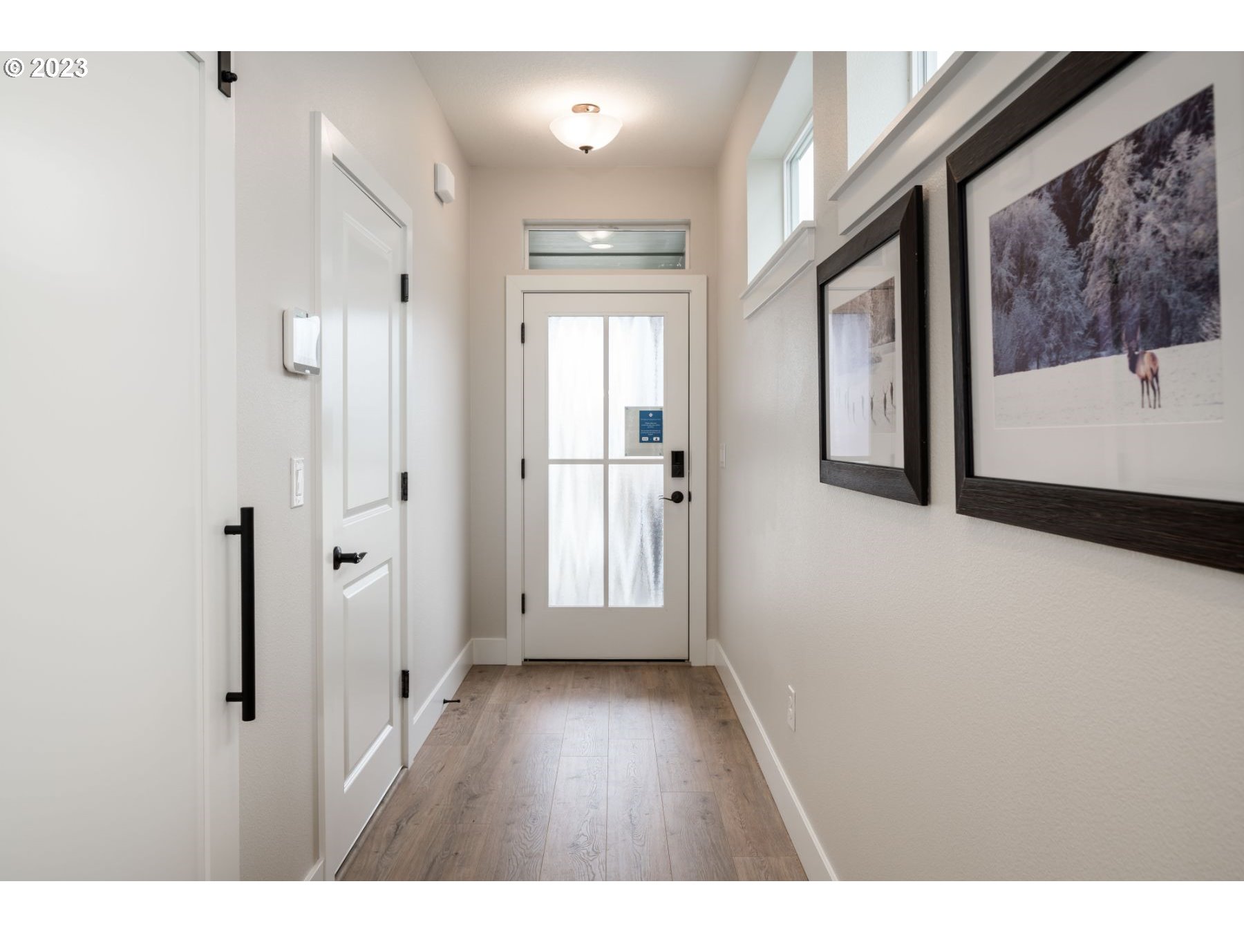 17531 Northwest 7th Avenue Ridgefield, WA 98642 - Photo 3 of 27 a view of a hallway with wooden floor and front door