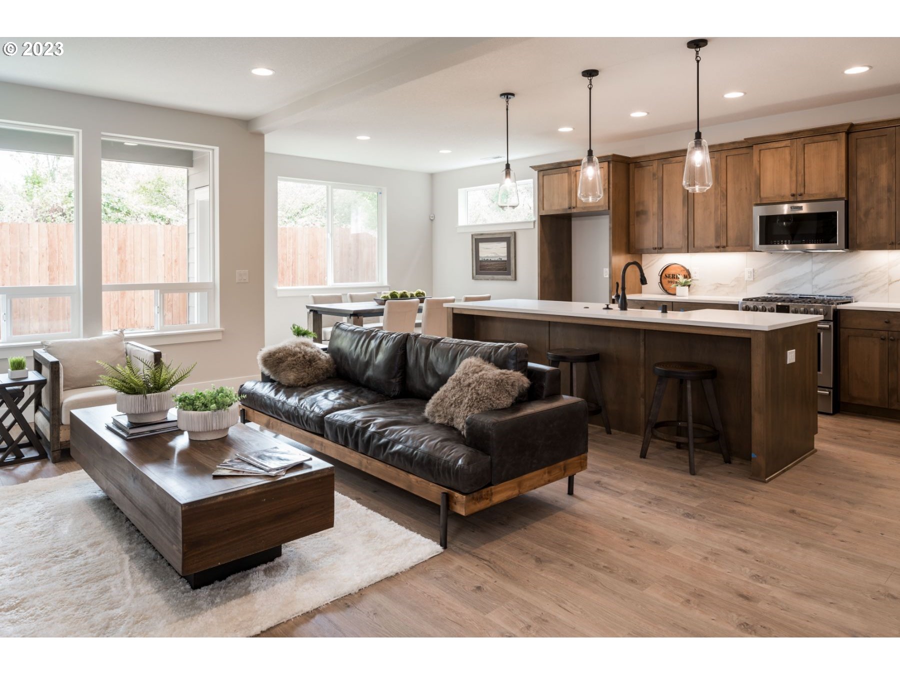 17531 Northwest 7th Avenue Ridgefield, WA 98642 - Photo 4 of 27 a living room with kitchen island furniture and a wooden floor