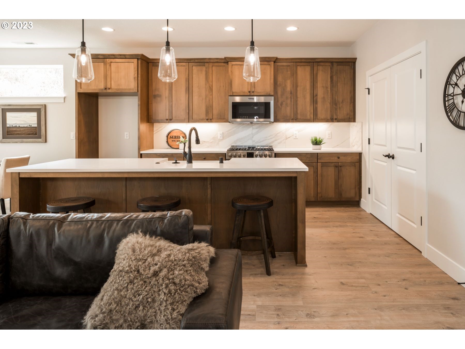 17531 Northwest 7th Avenue Ridgefield, WA 98642 - Photo 5 of 27 a kitchen with kitchen island granite countertop a sink cabinets and wooden floor
