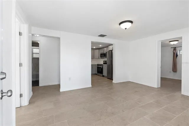 an empty room with closet and a window