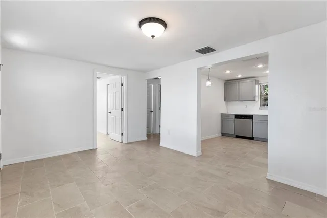 an empty room with a kitchen and a sink