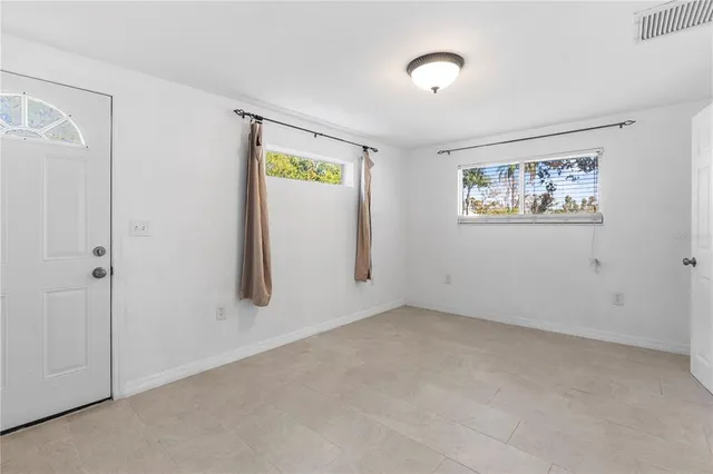 an empty room with windows and closet