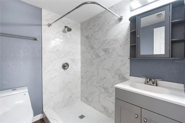 a bathroom with a sink a mirror and a shower