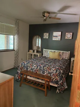 a bed sitting in a bedroom next to a window