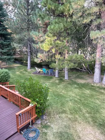 a view of a chair and table on the wooden deck