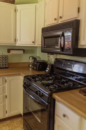 a stove top oven sitting inside of a kitchen