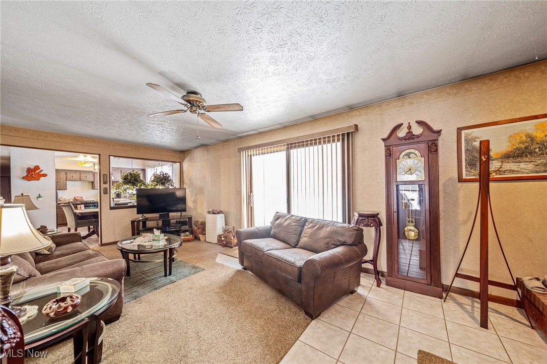 12430 Butternut Road Chardon, OH 44024 - Photo 13 of 33 Living area featuring ceiling fan, a textured ceiling, and light tile patterned floors