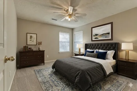 a view of a house with backyard and sitting area