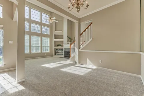a dining room with furniture a chandelier and window
