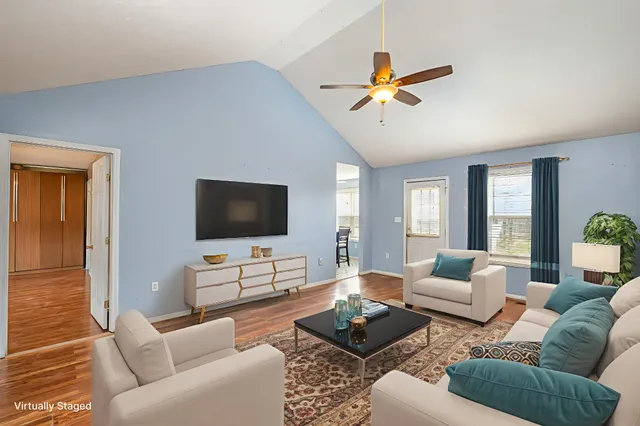 a living room with furniture and a flat screen tv