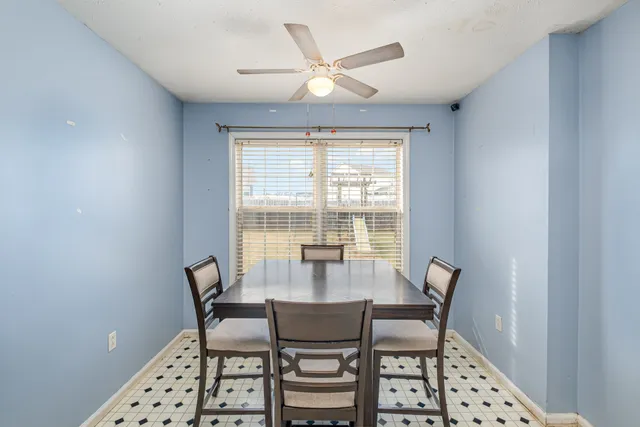 a dining room with furniture and window