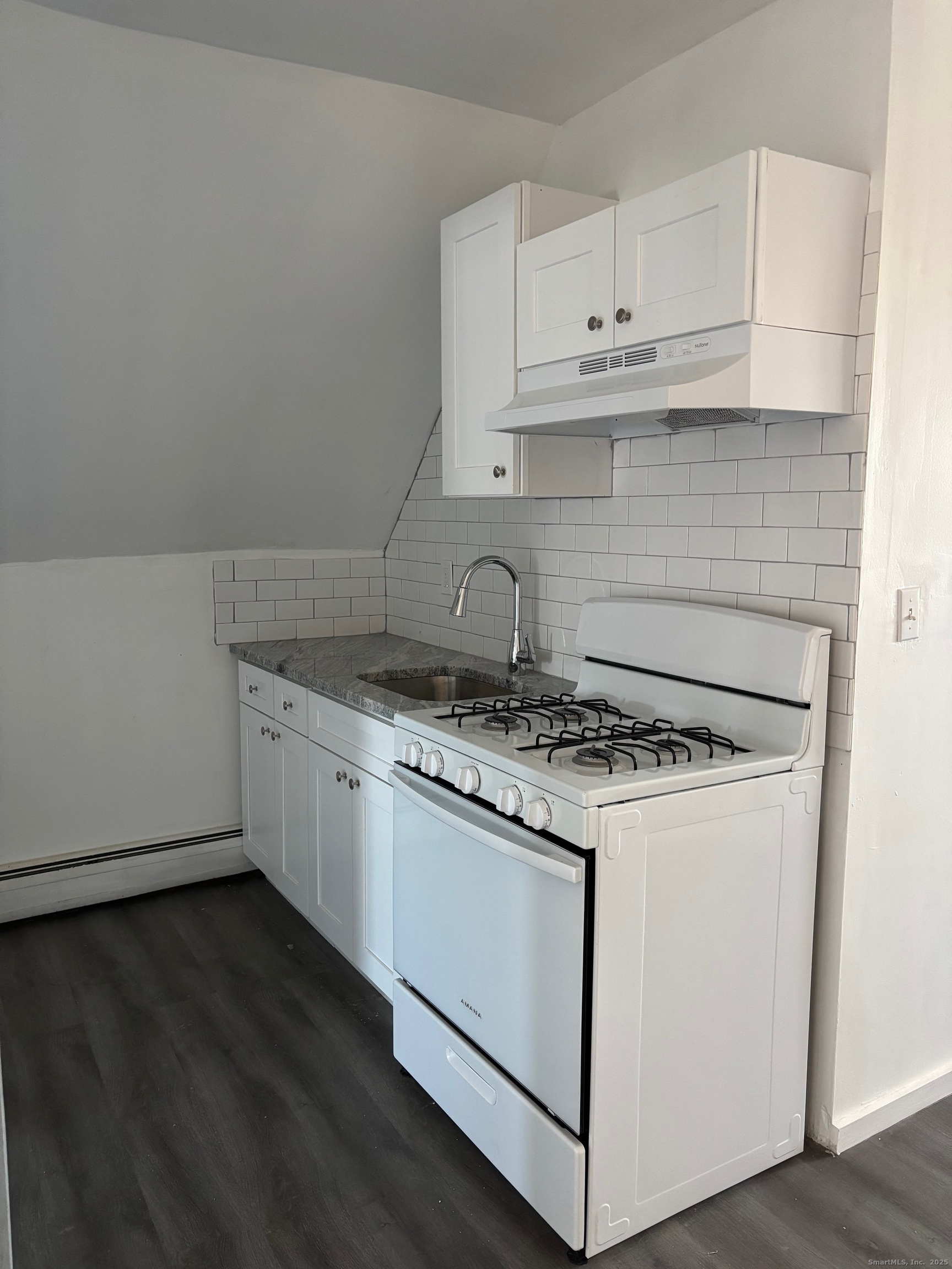 464 Wilmot Avenue Bridgeport, CT 06607 - Photo 15 of 19 a kitchen with granite countertop white cabinets and white appliances