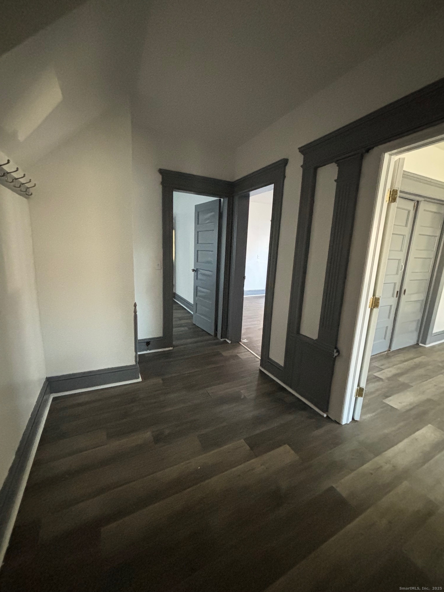 464 Wilmot Avenue Bridgeport, CT 06607 - Photo 19 of 19 an empty room with wooden floor and windows