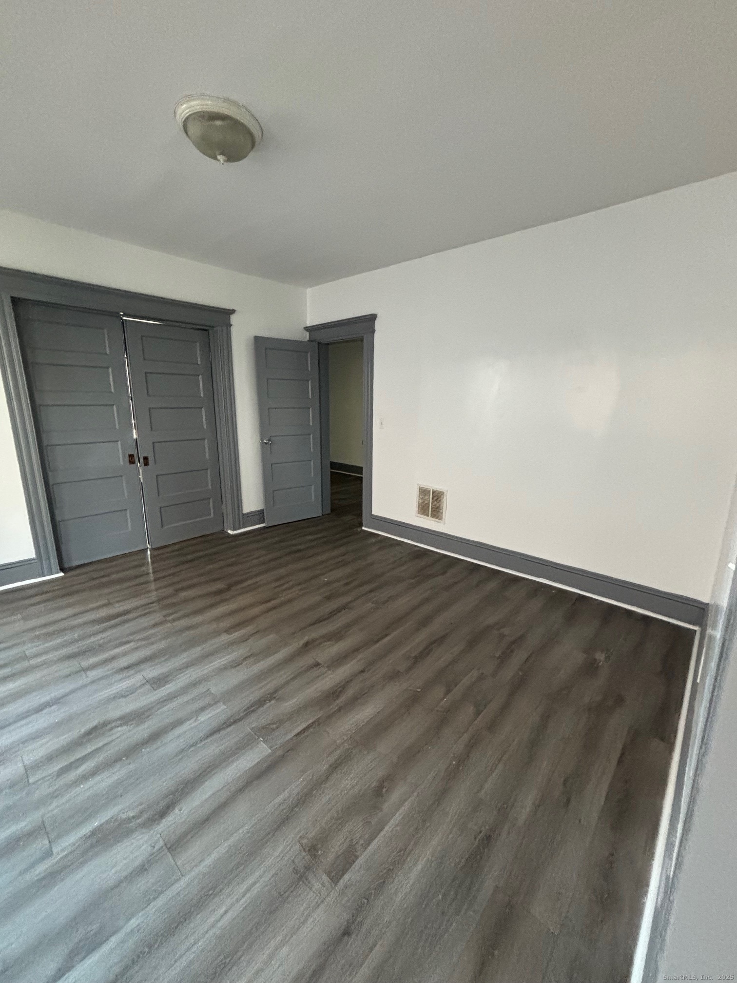 464 Wilmot Avenue Bridgeport, CT 06607 - Photo 8 of 19 wooden floor in an empty room