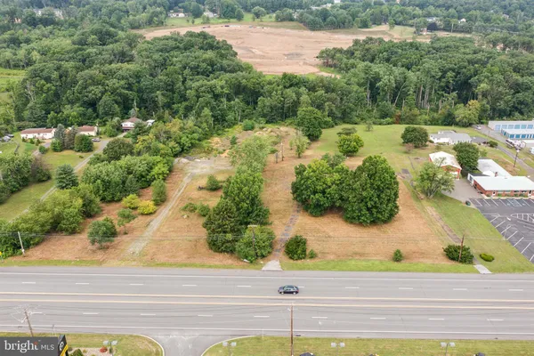 an aerial view of a house with a yard and lake view