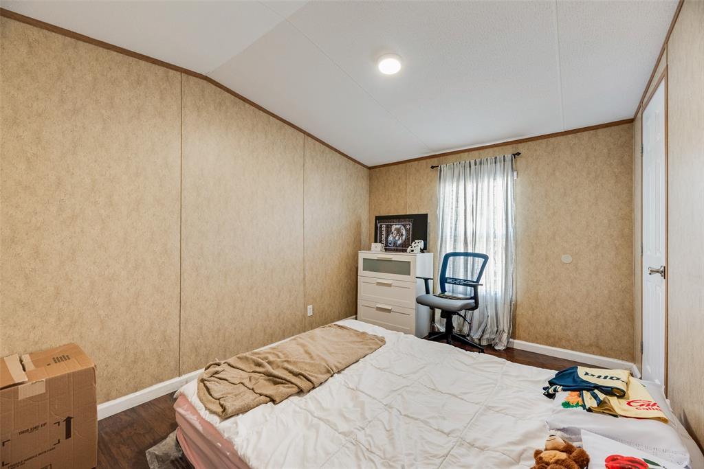 958 Watkins Road Sherman, TX 75090 - Photo 10 of 23 Wood-finish flooring, recessed ceiling lighting, light-toned wall paneling, and a window with curtain rod