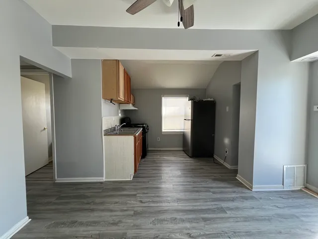 a view of kitchen with sink and wooden floor