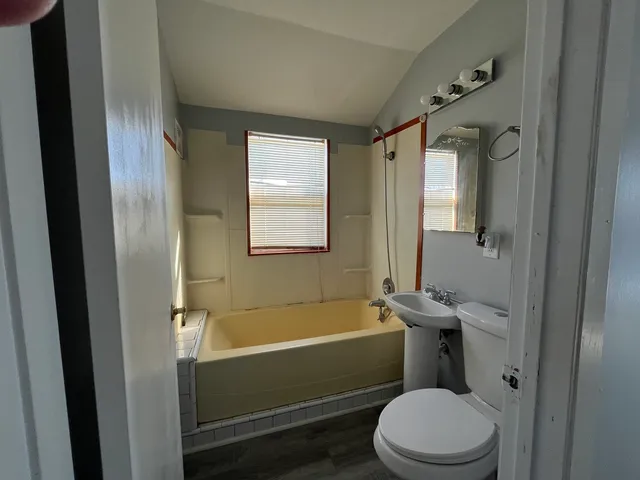 a bathroom with a toilet and a bathtub