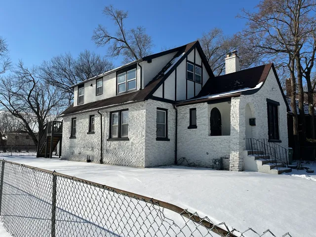 a view of a house with a snow in the yard