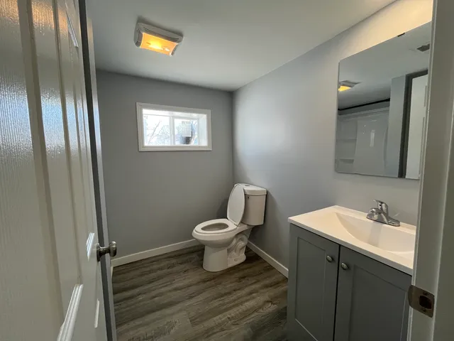 a bathroom with a toilet sink and mirror