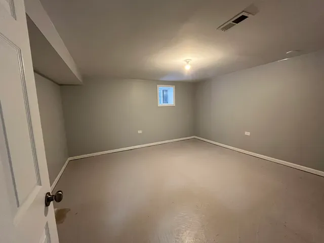 an empty room with a empty space and windows