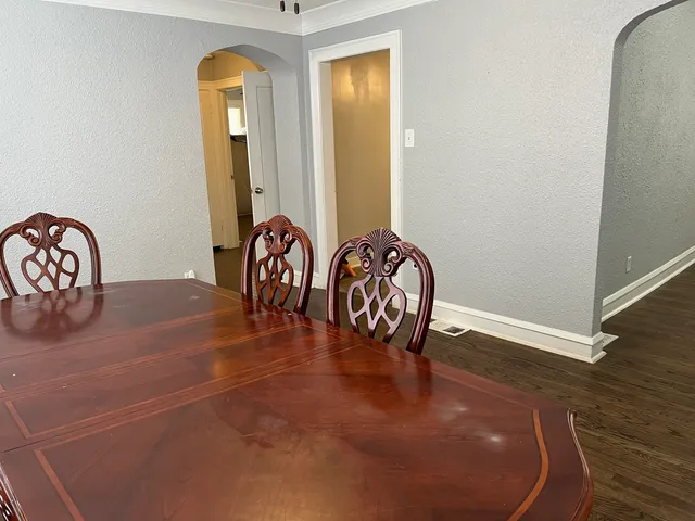 wooden floor with table and chairs