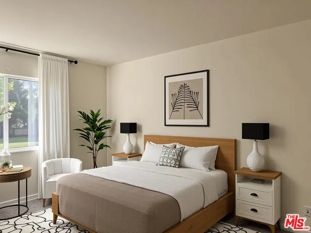 a bedroom with bed and a potted plant